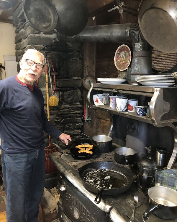 Eben's father cooking MyBacon on the family farm wood stove